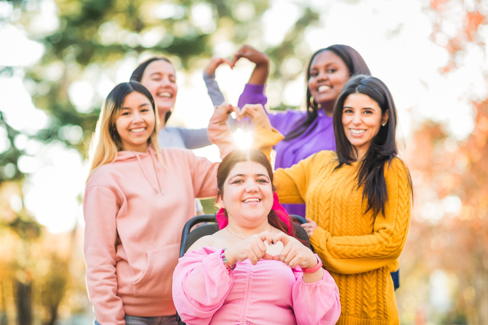 Inspire Inclusion international womens day. Diverse group do heart love with hands. Disability